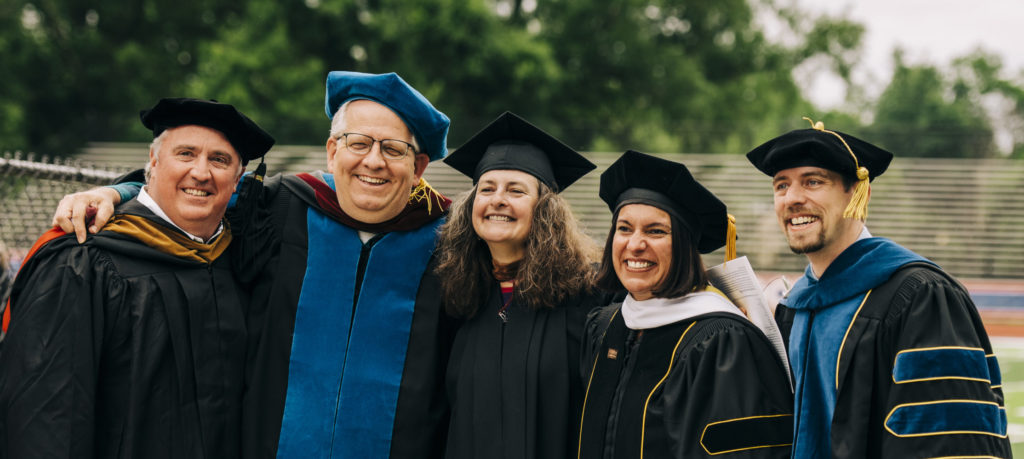 Five professors in academic regalia