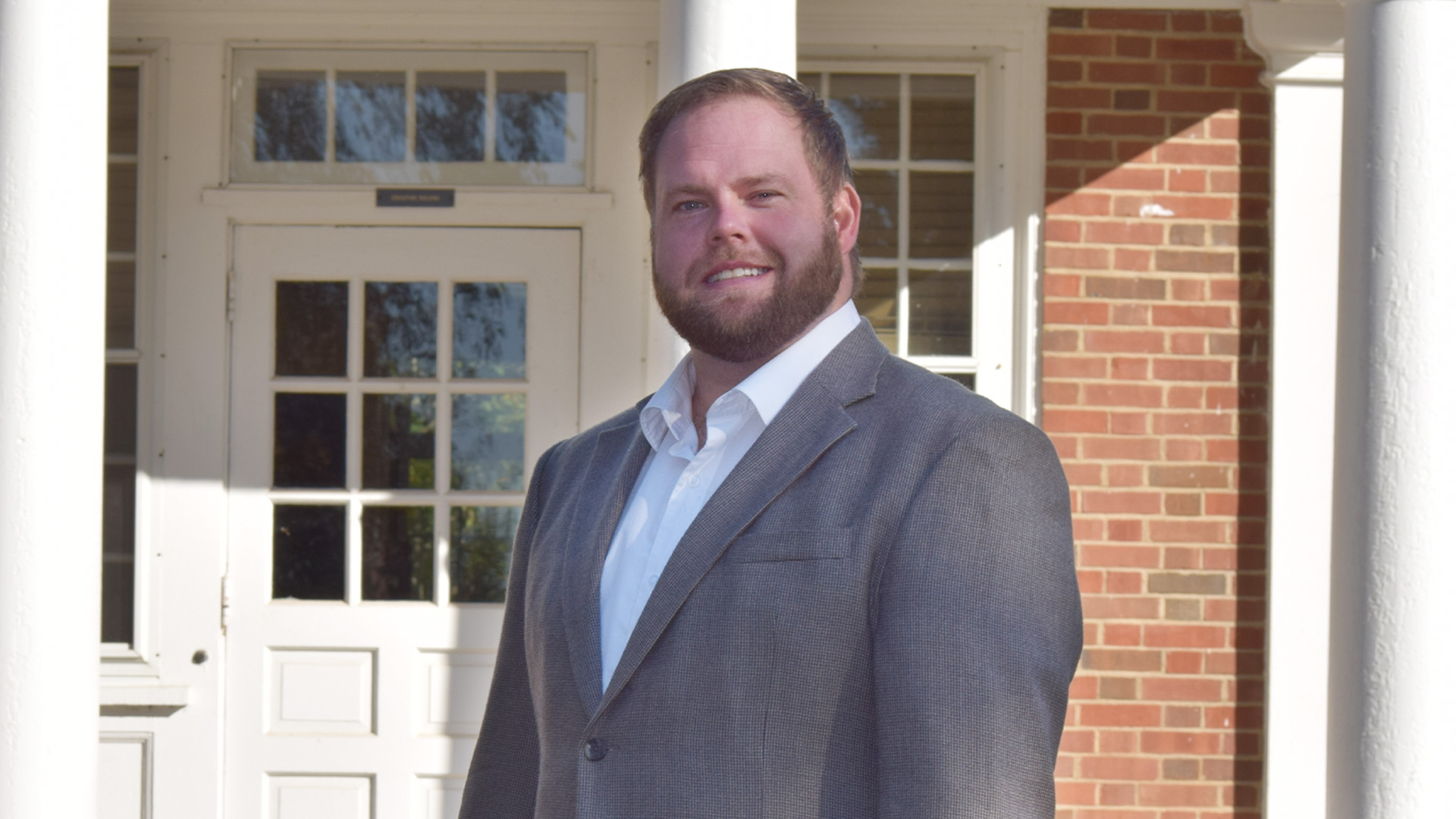 dustin bailey poses in front of newby hall