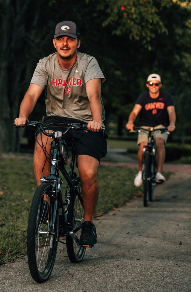 Two students riding bicycles on Hanover's campus