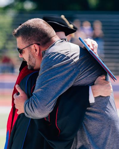 Clint Riggles accepts honorary bachelor's degree in memory of his daughter, Lexi Riggles '22