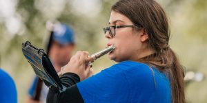 student playing flute at outdoor concert