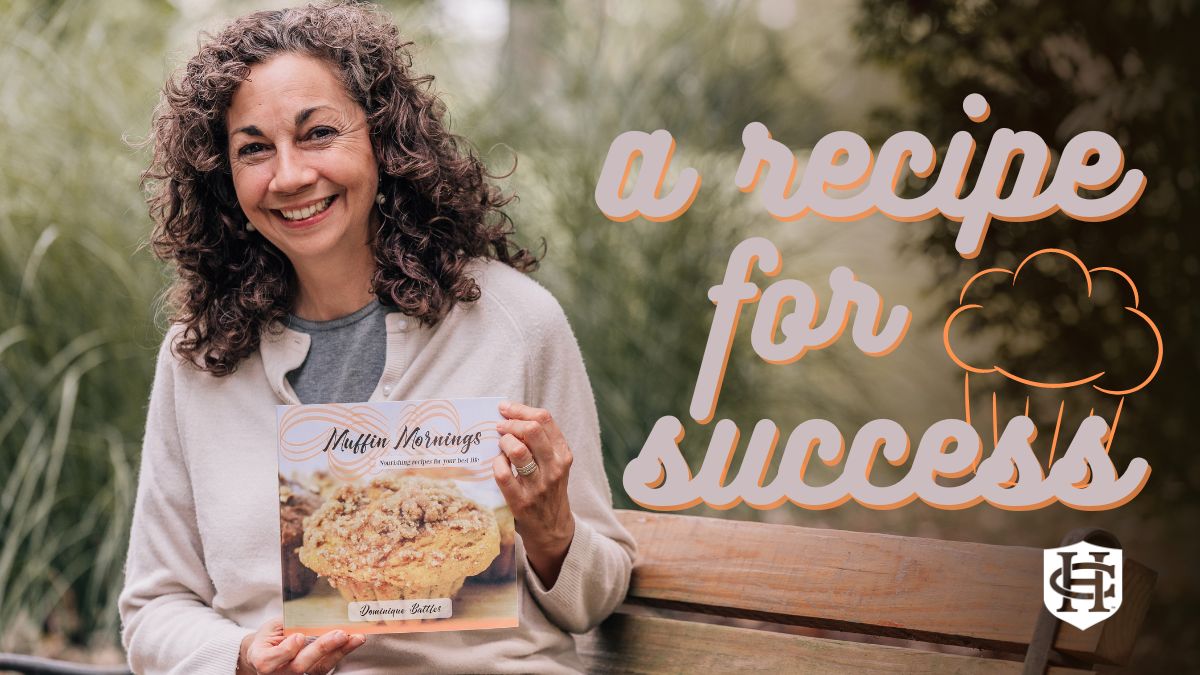 Dominique Battles holding recipe book while sitting on bench