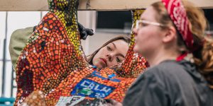 Environmental art students assemble homage to Miami Tribe Students placing tiles on bison art project