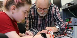 instructor and student with electrical equipment