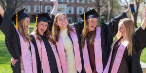 Five female graduating seniors celebrating