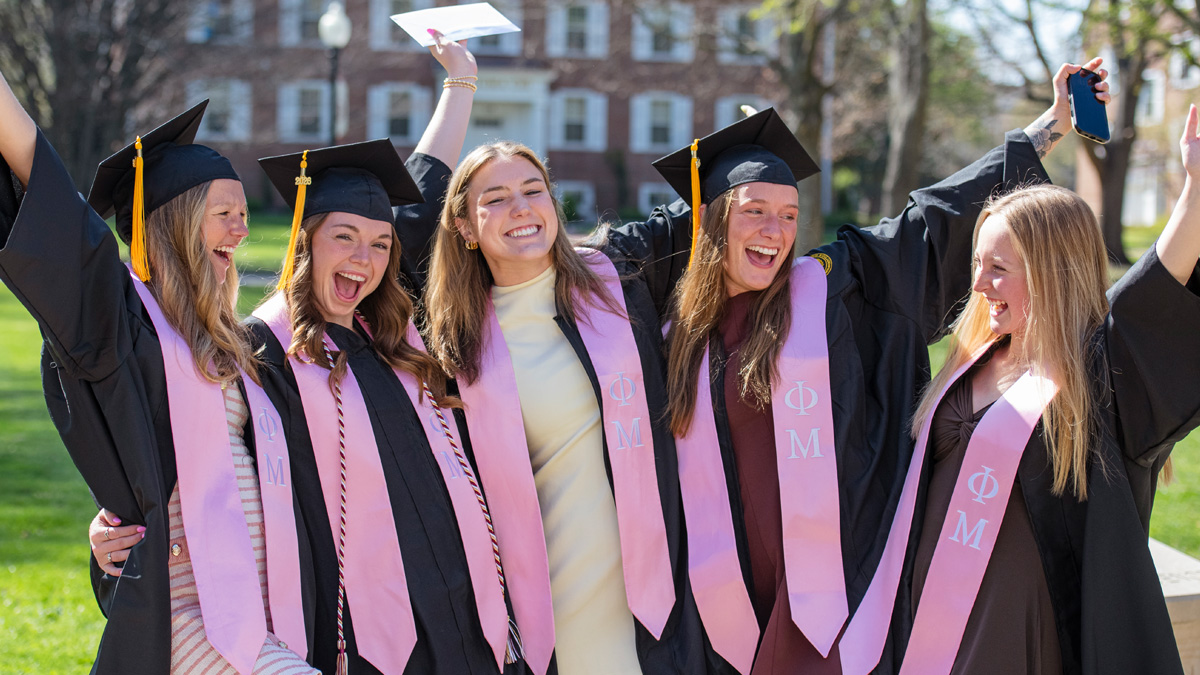 Five female graduating seniors celebrating